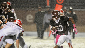 Joliet Catholic's Michael Johnson (23) with the carry in the heavy rain on Friday, October 23, 2015. (Warren Skalski / Chicago Tribune)